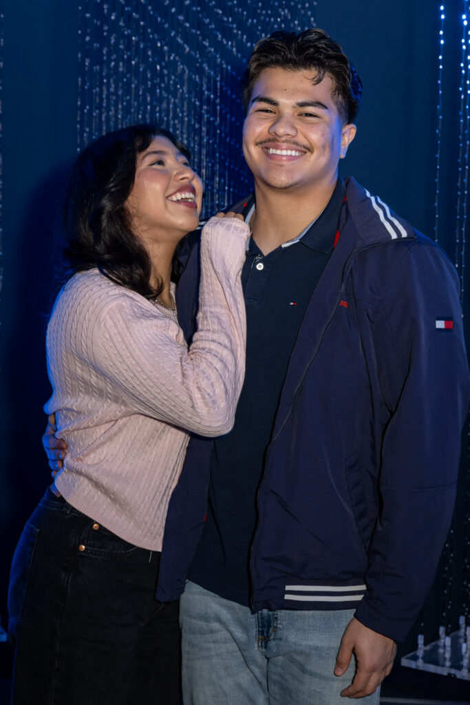 couple gazing longingly at each other with immersive backdrop