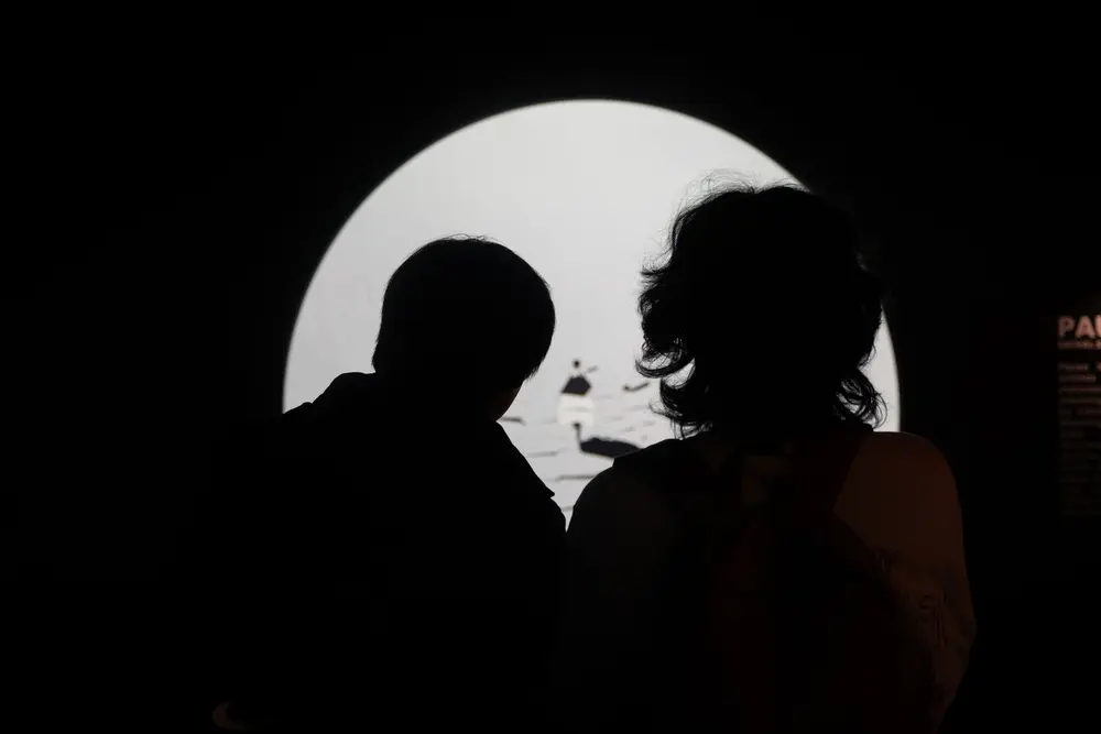 couple looking at an interactive art piece very seriously