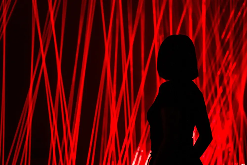 girl with a bright red laser backdrop